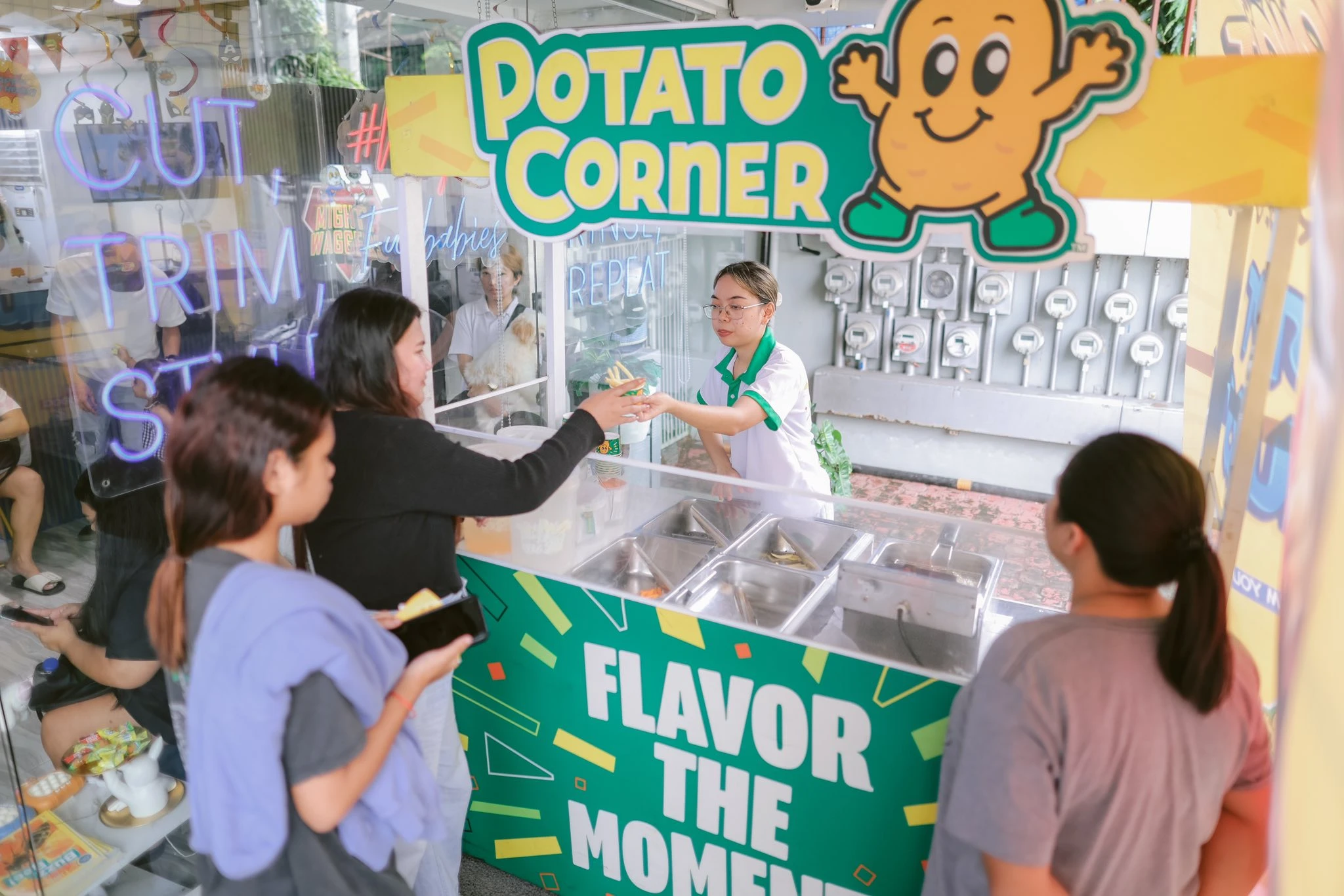 Customers getting free fries at the Potato Corner booth during the Mighty Waggers 3rd Birthday Blowout event.